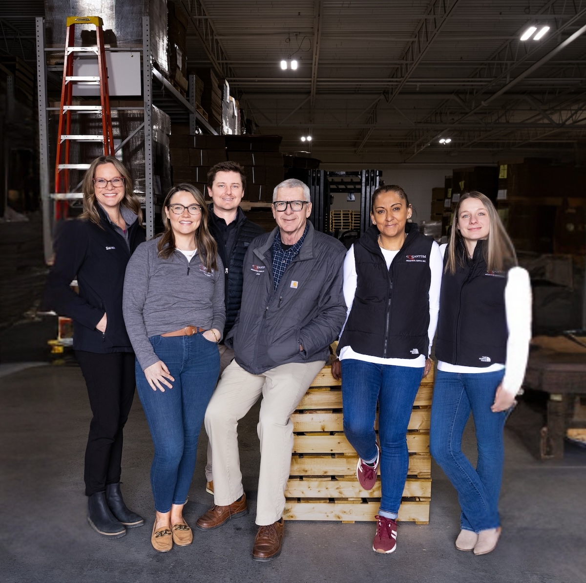 Quantum Industrial team posing in the warehouse